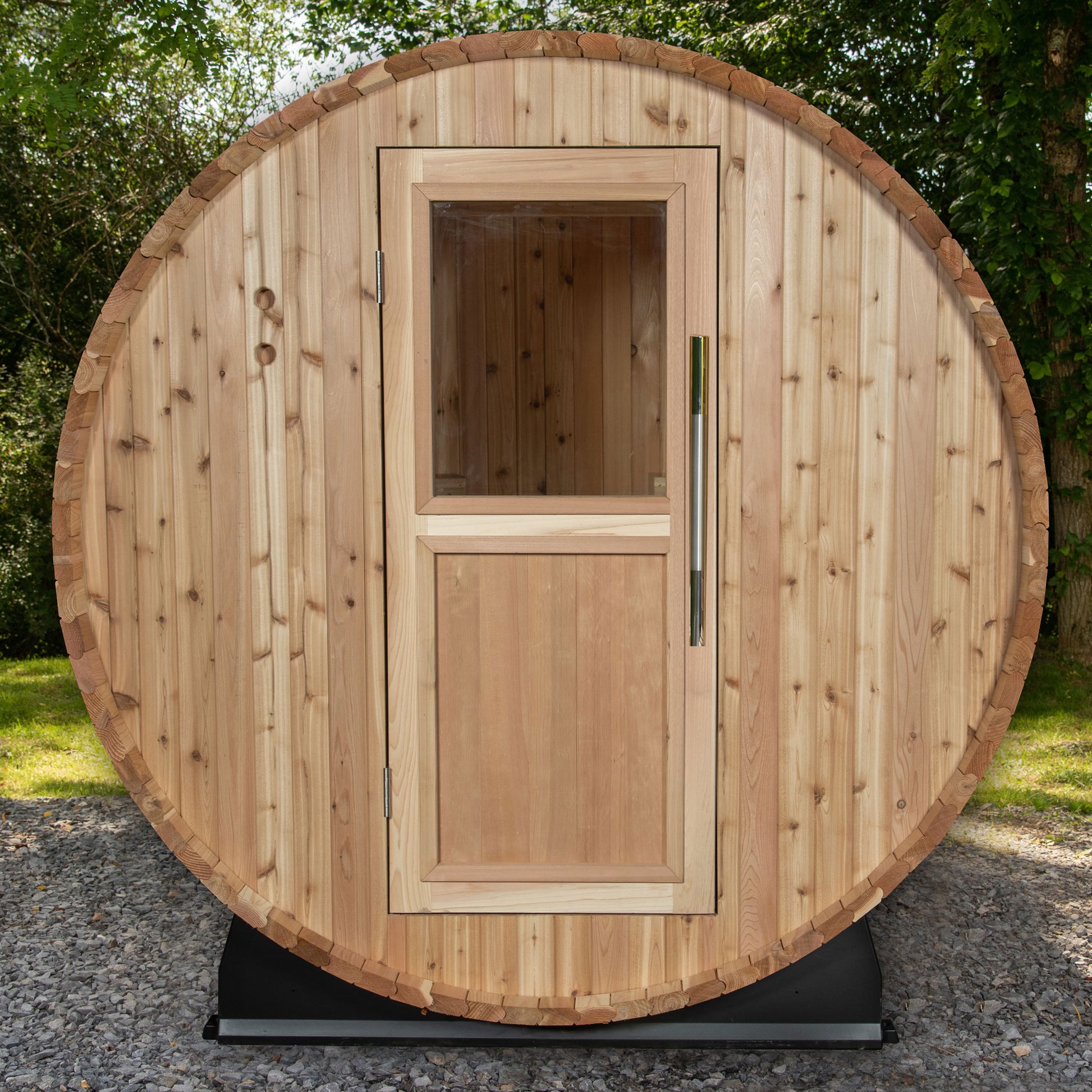 Classic Watoga barrel sauna with a wooden door including a window.